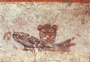 El símbolo eucarístico de los panes y los peces. Catacumbas de San Calixto. Roma